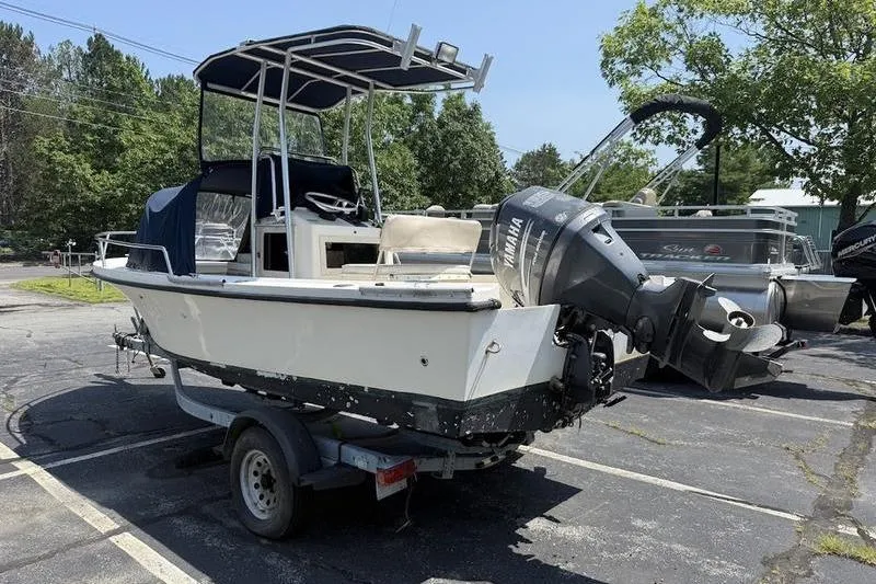 Slide: The Image of 1996 Parker 18 CC boat on trailer with Yamaha outboard motor in parking lot. - 4