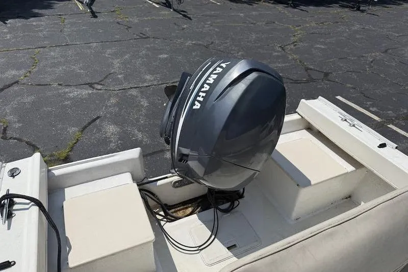 Slide: The Image of 1996 Parker 18 CC boat with Yamaha outboard motor in a parking lot. - 7