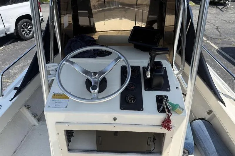 Slide: The Image of 1996 Parker 18 CC boat console with steering wheel and controls. - 9