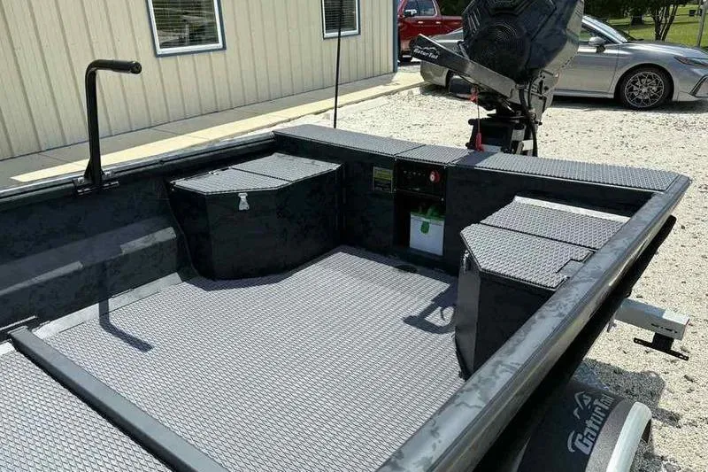 Slide: The Image of 2025 Gator Tail 1860 Extreme boat interior with storage compartments and motor. - 11