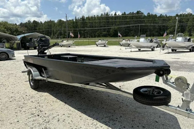 Slide: The Image of 2025 Gator Tail 1860 Extreme boat on trailer in outdoor dealership lot. - 2