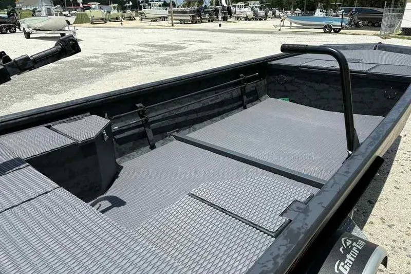 Slide: The Image of 2025 Gator Tail 1860 Extreme boat interior with textured flooring, parked outdoors. - 3