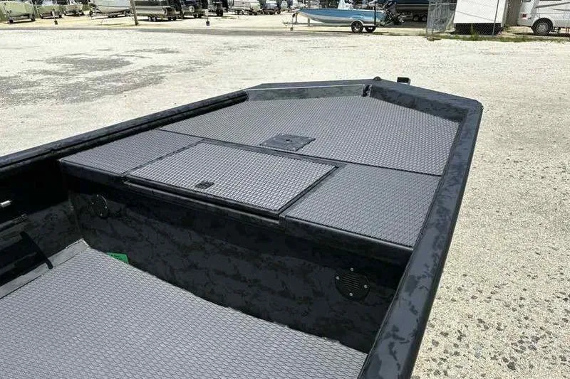 Slide: The Image of 2025 Gator Tail 1860 Extreme boat interior with textured flooring, parked outdoors. - 4