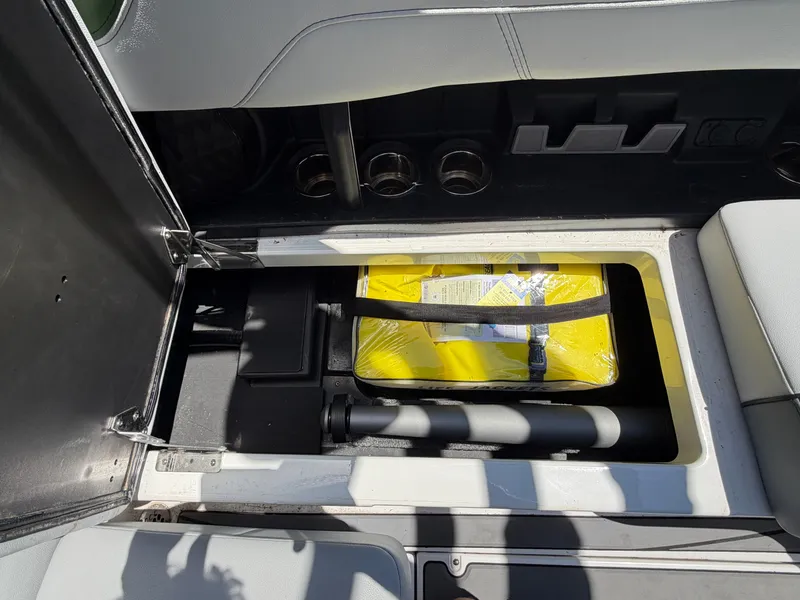 Slide: The Image of An open storage compartment in a boat reveals a yellow bag and other items. - 25