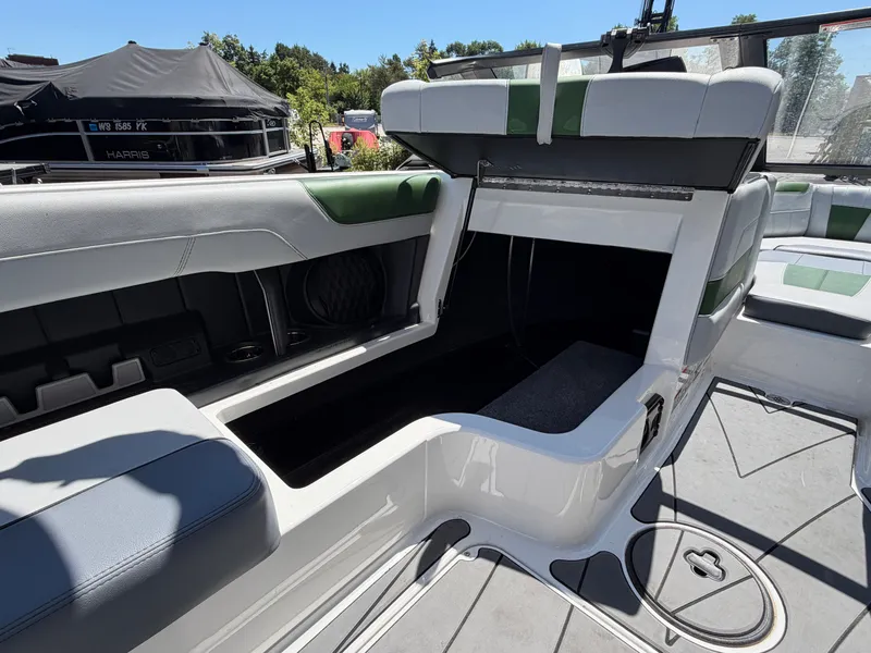 Slide: The Image of The image shows the interior of a 2023 Malibu Wakesetter 20 VTX with seating and storage. - 28