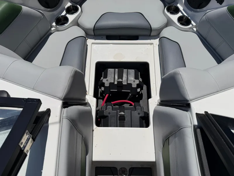 Slide: The Image of The image shows the interior of a 2023 Malibu Wakesetter 20 VTX with gray upholstery and an open battery compartment. - 45