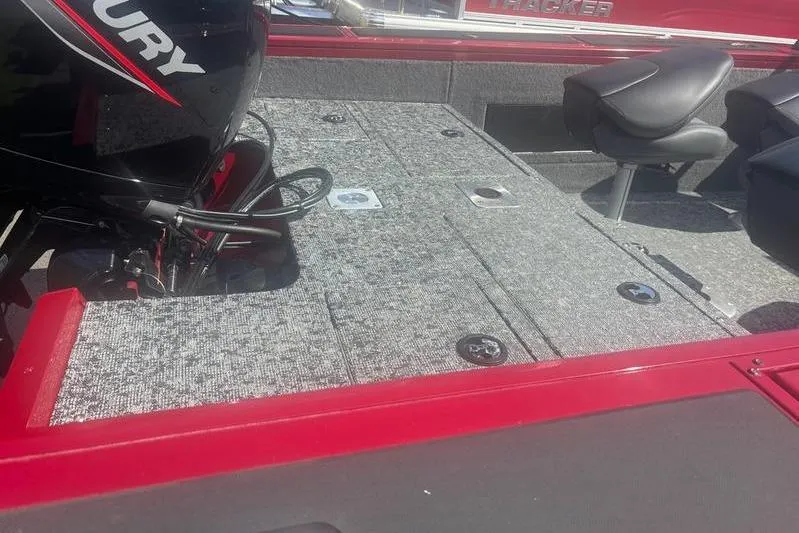 Slide: The Image of 2026 Tracker Targa V18 WT boat interior with Mercury engine and seating. - 4