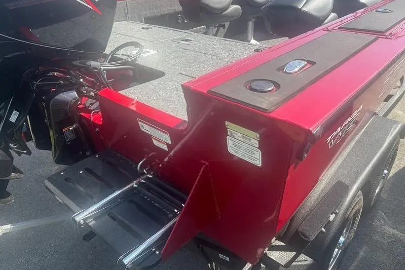 Slide: The Image of 2026 Tracker Targa V18 WT boat with red exterior and motor, featuring a rear ladder. - 6