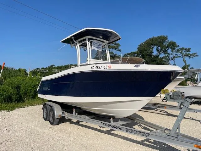 The Image of 2016 Robalo 2220 Center Console boat on trailer, parked outdoors. - 0