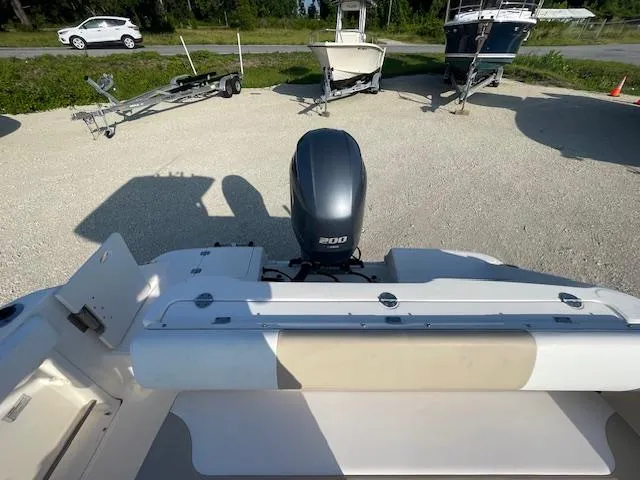 Slide: The Image of 2016 Robalo 2220 Center Console boat with 200 HP engine, parked on gravel. - 12