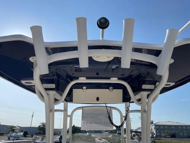 Slide: The Image of 2016 Robalo 2220 Center Console boat, view of T-top and rod holders. - 8
