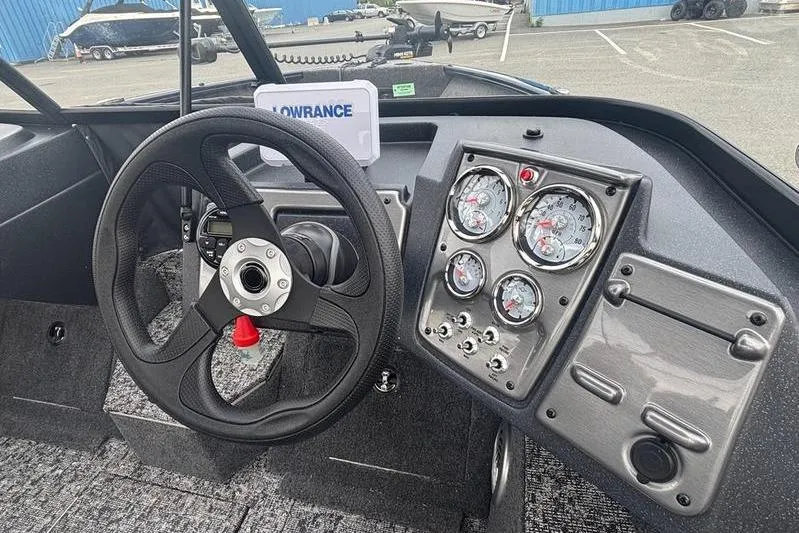 Slide: The Image of 2026 Tracker PG V175 WT boat dashboard with steering wheel and gauges. - 10