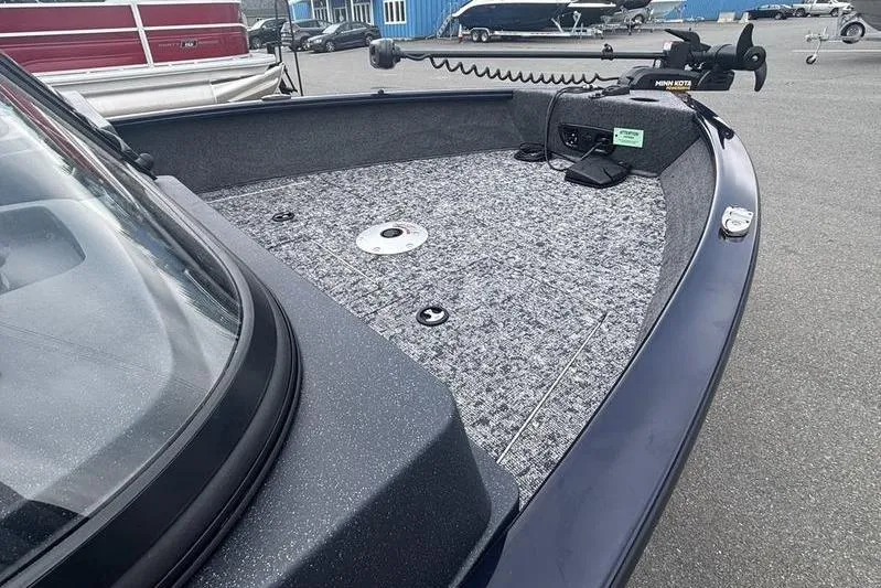 Slide: The Image of 2026 Tracker PG V175 WT boat deck with trolling motor, parked on asphalt. - 13