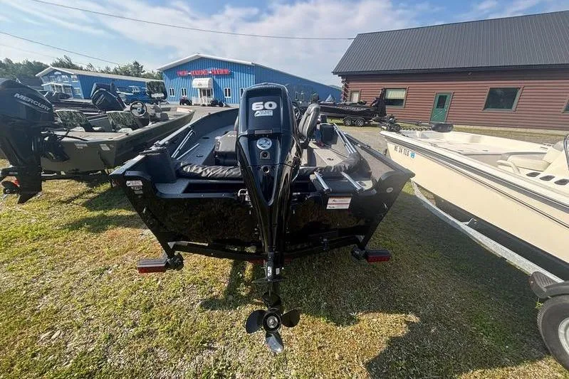 Slide: The Image of 2026 Tracker PG V175 WT boat with 60 HP Mercury engine displayed outdoors. - 4