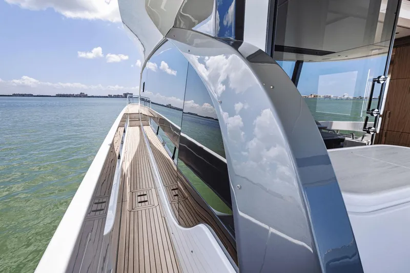 Slide: The Image of Azimut Fly 72 yacht, 2025 model, sleek design with reflective surfaces and wooden deck. - 12