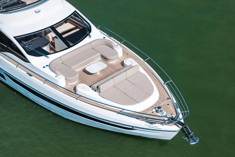 Slide: The Image of 2025 Azimut Fly 72 yacht with spacious deck and luxurious seating on calm water. - 14