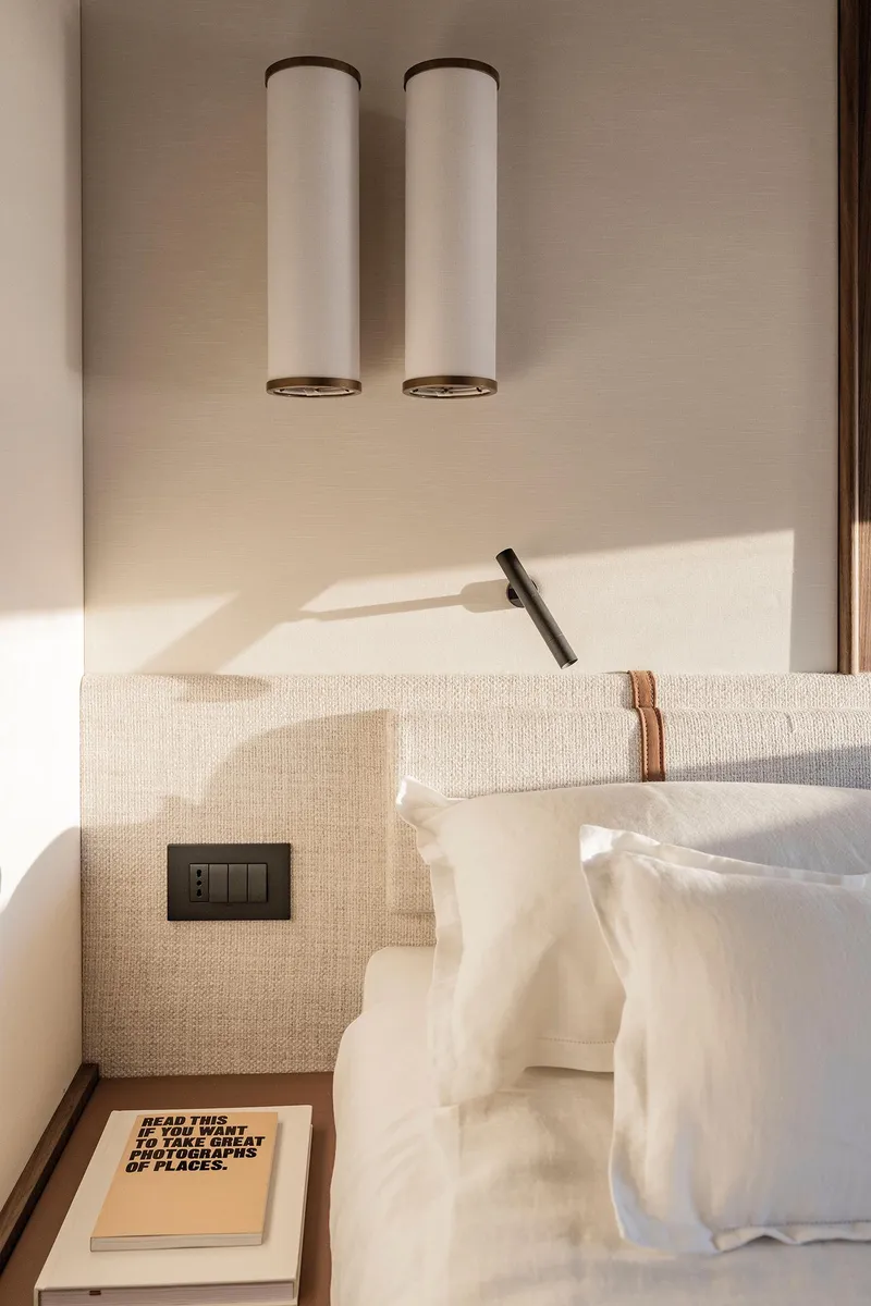 Slide: The Image of Luxurious bedroom interior of 2025 Azimut Fly 72 yacht with elegant lighting and cozy bedding. - 24