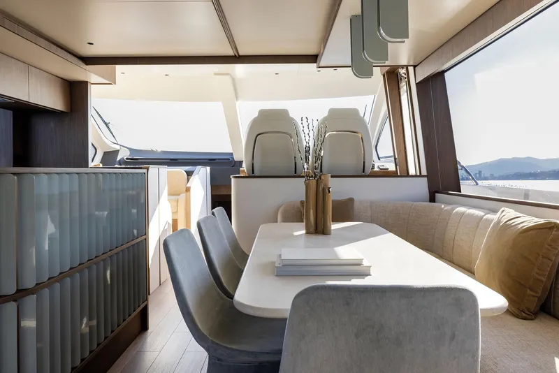 Slide: The Image of Luxurious interior of 2025 Azimut Fly 72 yacht with elegant dining area and panoramic windows. - 27