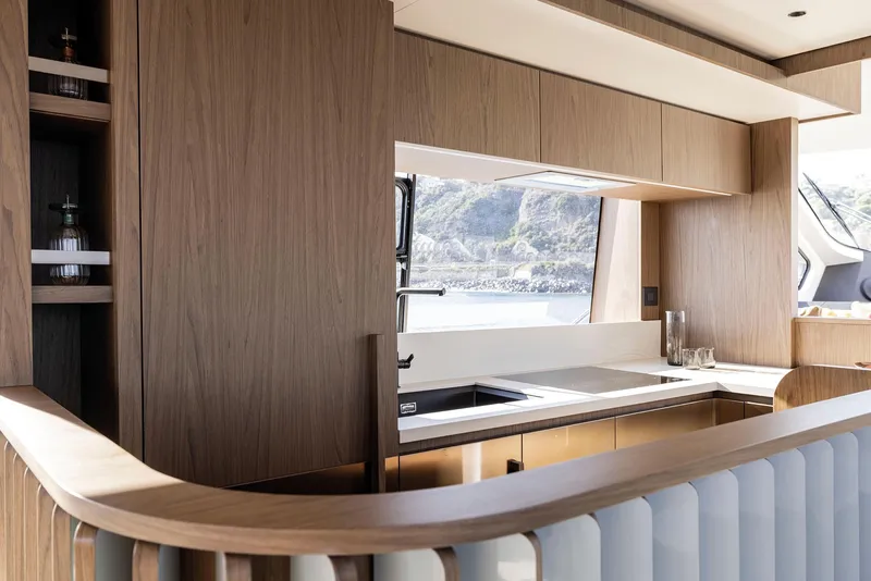 Slide: The Image of Luxurious kitchen interior of 2025 Azimut Fly 72 yacht with modern wood finishes. - 48