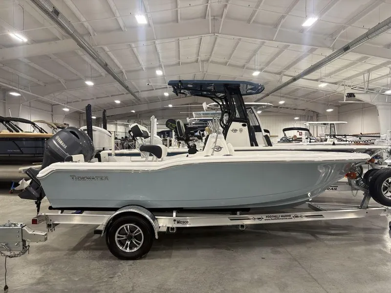Slide: The Image of 2026 Tidewater 180 CC Adventure boat in showroom, side view on trailer. - 1