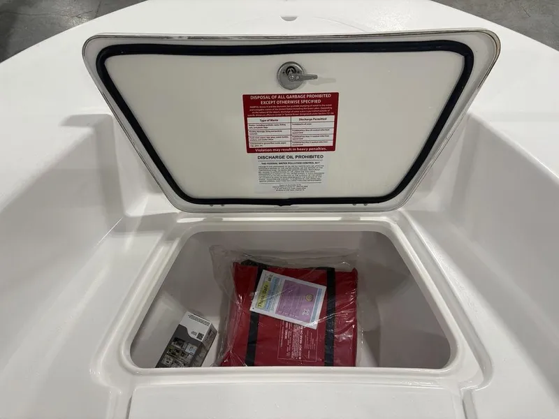 Slide: The Image of Open storage compartment on 2026 Tidewater 180 CC Adventure boat with safety equipment inside. - 11