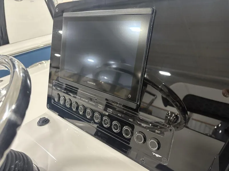 Slide: The Image of 2026 Tidewater 180 CC Adventure boat dashboard with Garmin display and control panel. - 14