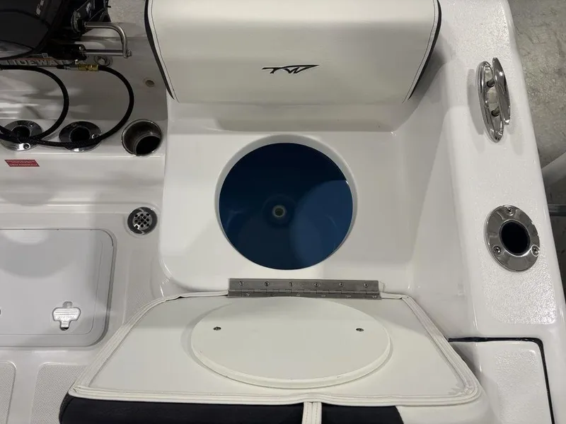Slide: The Image of 2026 Tidewater 180 CC Adventure boat interior with storage and seating area. - 19
