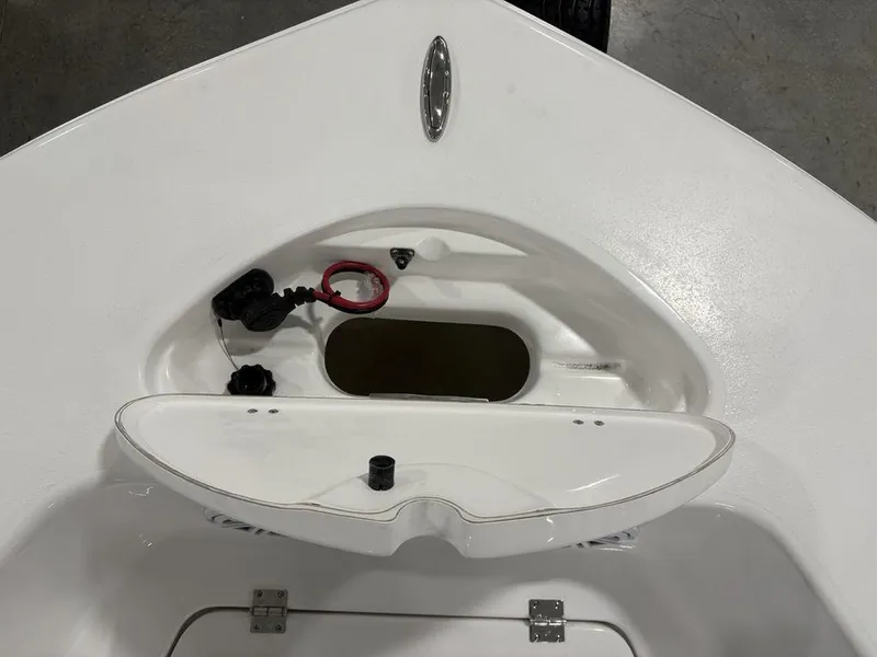 Slide: The Image of 2026 Tidewater 180 CC Adventure boat storage compartment with red and black cables. - 4