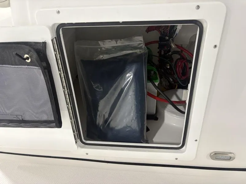 Slide: The Image of Storage compartment of 2026 Tidewater 180 CC Adventure boat, showing interior equipment and wiring. - 7