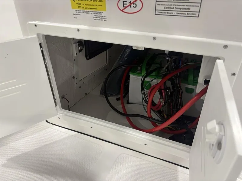 Slide: The Image of Open compartment of 2026 Tidewater 180 CC Adventure boat showing battery and wiring. - 9