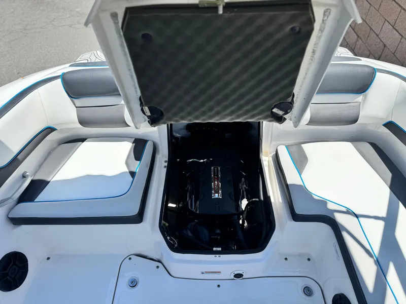 Slide: The Image of 2020 Yamaha AR195 boat interior with open engine compartment, showcasing seating and design. - 16