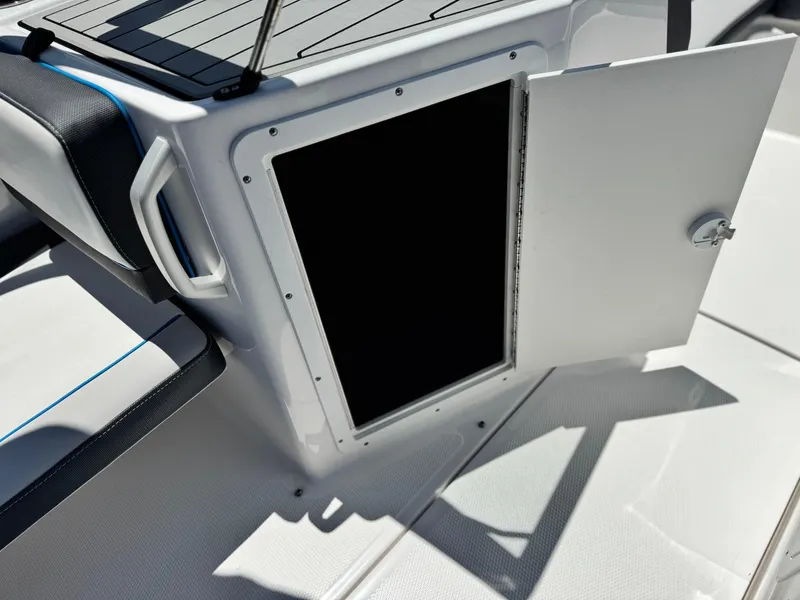Slide: The Image of 2020 Yamaha AR195 boat storage compartment with open door, showcasing interior space. - 20