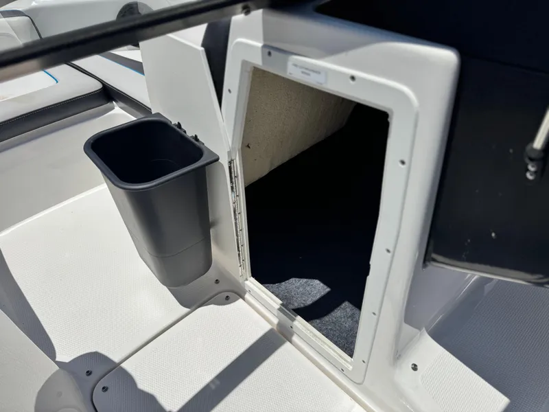 Slide: The Image of 2020 Yamaha AR195 boat interior storage compartment with trash bin. - 27