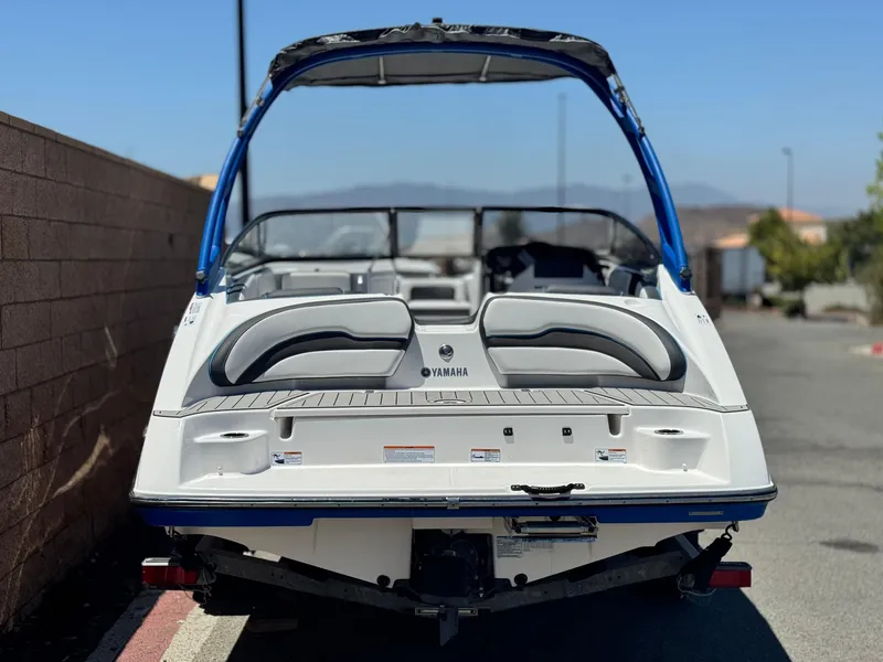 Slide: The Image of 2020 Yamaha AR195 boat, rear view, parked outdoors with blue canopy. - 4