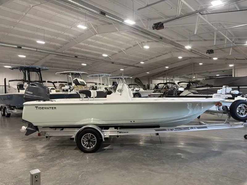 The Image of 2026 Tidewater 1910 BM boat displayed in a showroom on a trailer. - 1