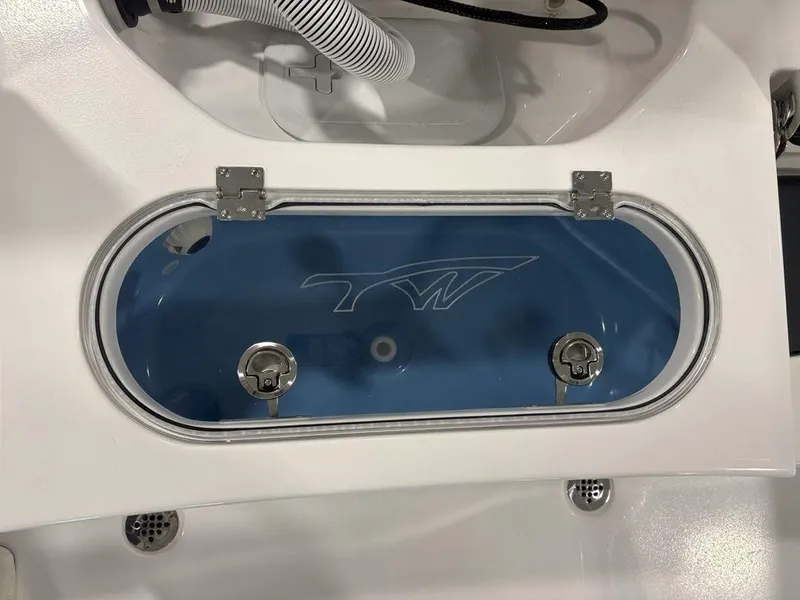 Slide: The Image of Livewell on 2026 Tidewater 1910 BM boat, featuring a blue interior and secure latches. - 17