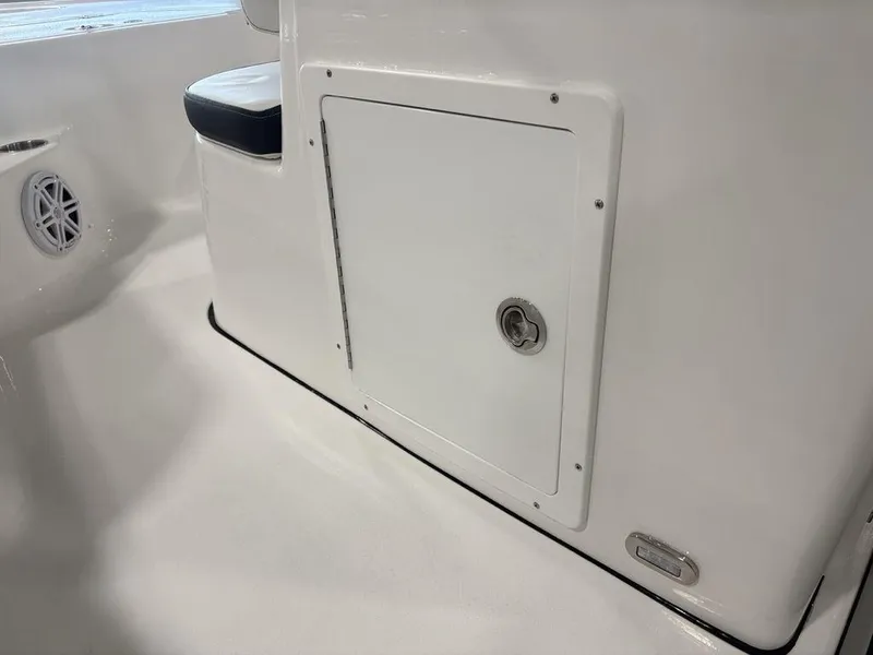 Slide: The Image of 2026 Tidewater 1910 BM boat interior, featuring a storage compartment and speaker. - 20