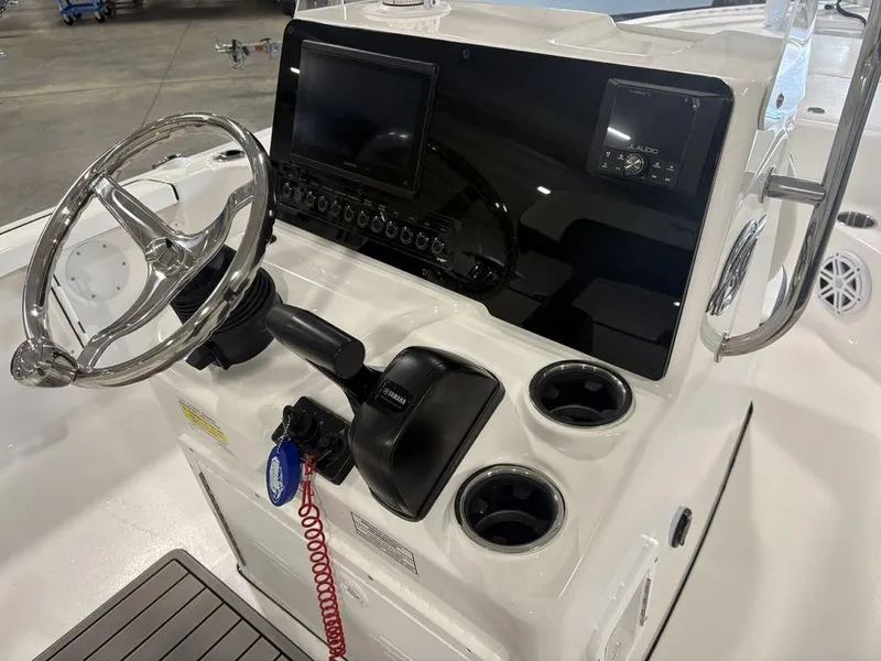 Slide: The Image of 2026 Tidewater 1910 BM boat console with steering wheel, controls, and cup holders. - 21