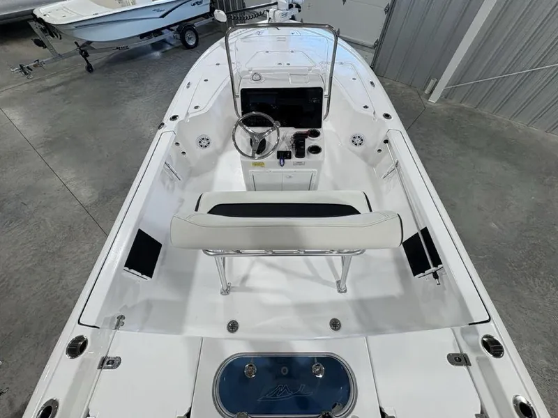 Slide: The Image of 2026 Tidewater 1910 BM boat interior with steering wheel and seating, displayed in a showroom. - 25