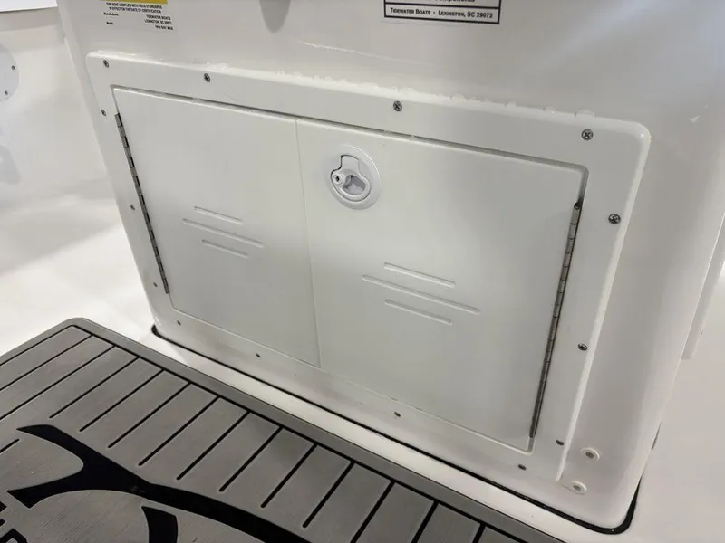 Slide: The Image of Storage compartment on a 2026 Tidewater 1910 BM boat, featuring a secure latch. - 28