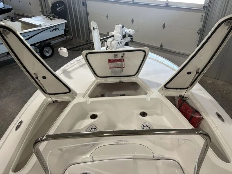 Slide: The Image of 2026 Tidewater 1910 BM boat interior with open storage compartments in a garage setting. - 7