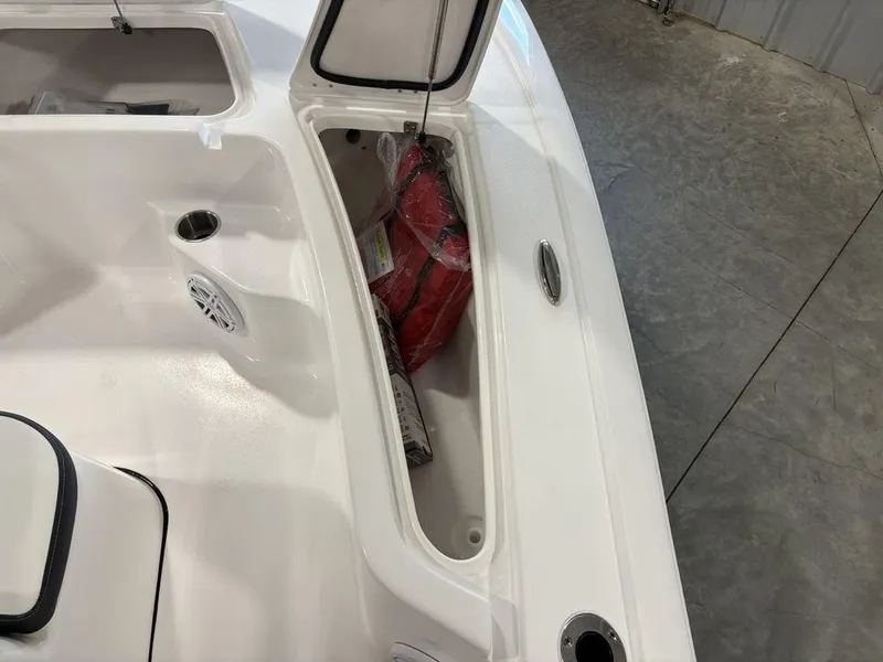 Slide: The Image of Open storage compartment on 2026 Tidewater 1910 BM boat, featuring a red life jacket. - 8