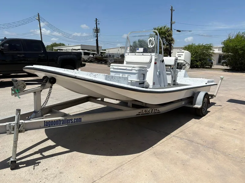 Slide: The Image of Custom 2013 boat on Lagoon trailer in sunny outdoor setting. - 12