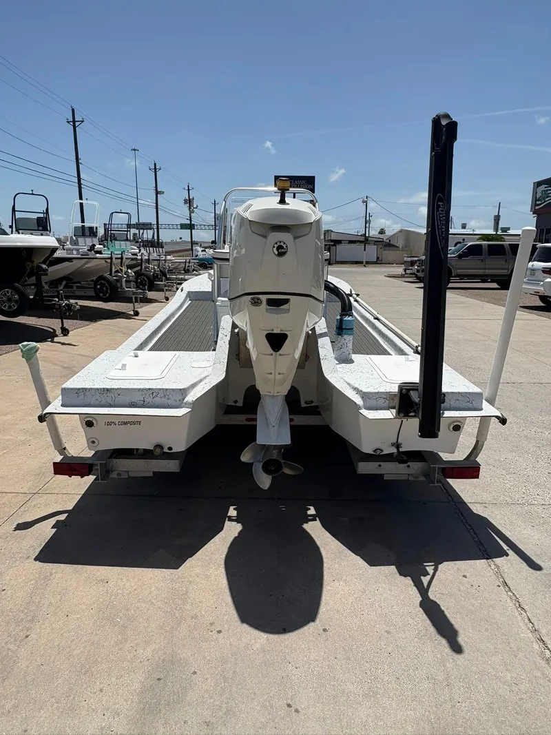 Slide: The Image of Rear view of a 2013 Custom model C boat on a trailer in a sunny lot. - 4