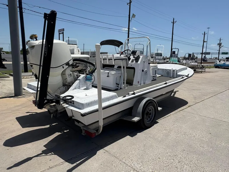 Slide: The Image of Custom 2013 boat on trailer, parked outdoors under clear blue sky. - 5