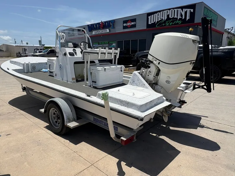 Slide: The Image of Custom 2013 boat on trailer outside Waypoint Supercenter, featuring outboard motor and fishing equipment. - 9