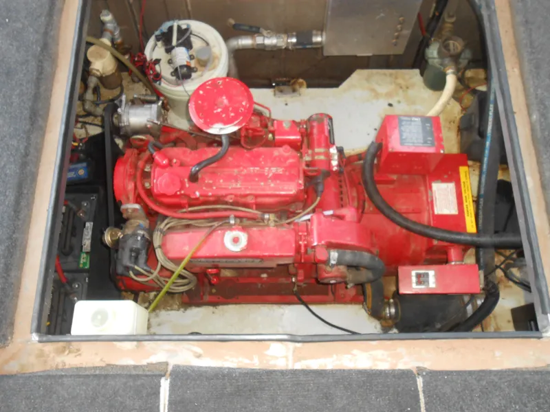Slide: The Image of Engine compartment of a 1996 Sea Ray 290 Sundancer boat, featuring a red engine. - 10