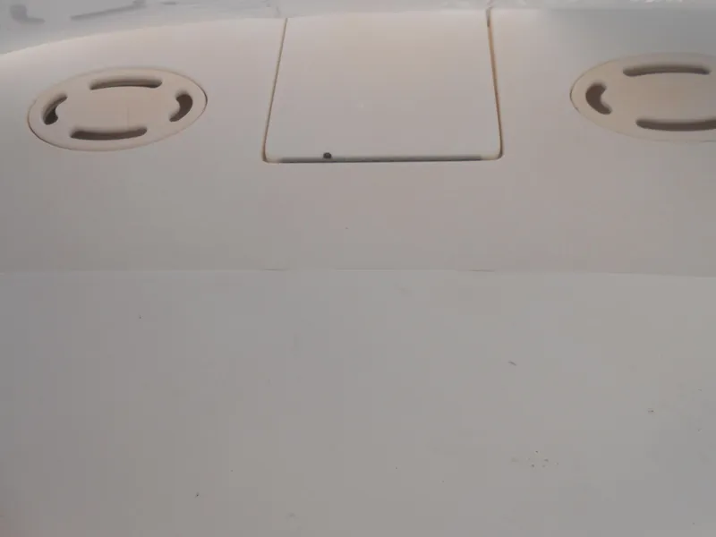 Slide: The Image of Deck of 1996 Sea Ray 290 Sundancer boat, featuring circular fittings and a central hatch. - 17