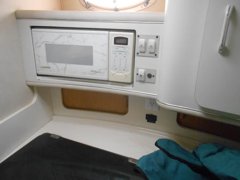 Slide: The Image of Interior of 1996 Sea Ray 290 Sundancer with microwave and control panel. - 22
