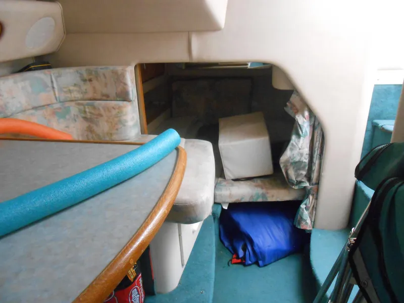 Slide: The Image of Interior of 1996 Sea Ray 290 Sundancer with seating and storage area. - 23
